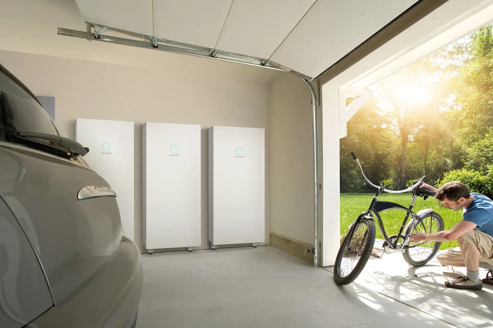 sonnenCore+ three-unit installation in a garage next to a bicycle